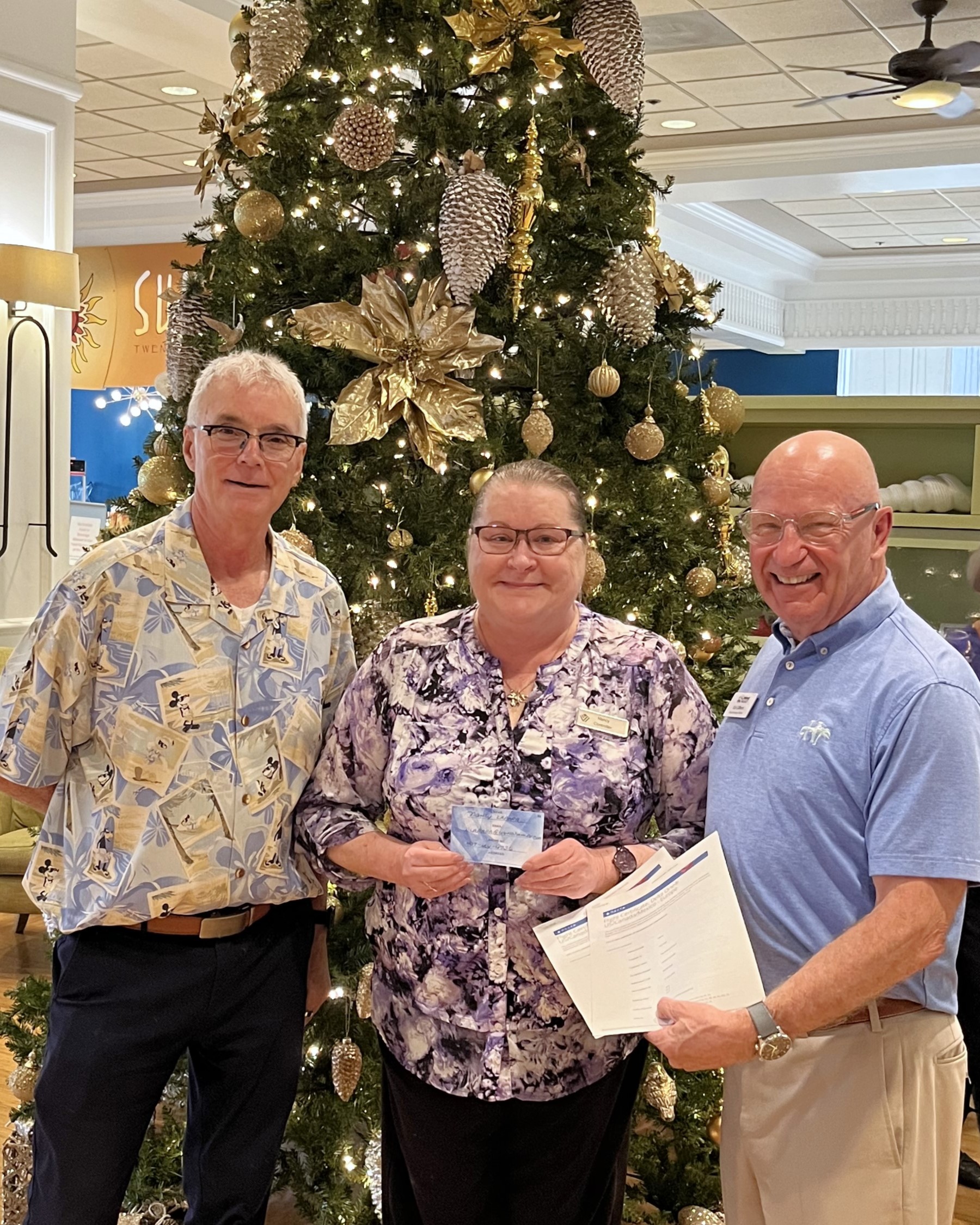 Jay Leonard and Ed Gilbert standing with the Delta Airlines Raffle Winner, Nancy Lapara!